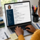 Student reviewing a professionally formatted scholarship CV on a laptop while preparing scholarship application documents